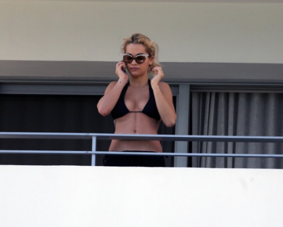 British singer Rita Ora in a black bikini on a balcony in Miami